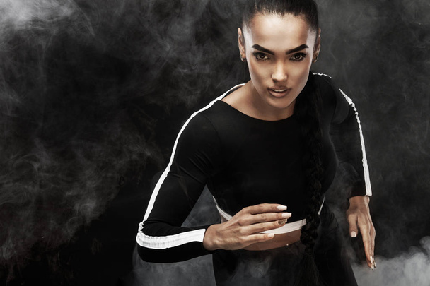 A strong athletic, woman sprinter, run. Girl wearing in the sportswear, fitness and sport motivation concept with copy space. - Фото, зображення