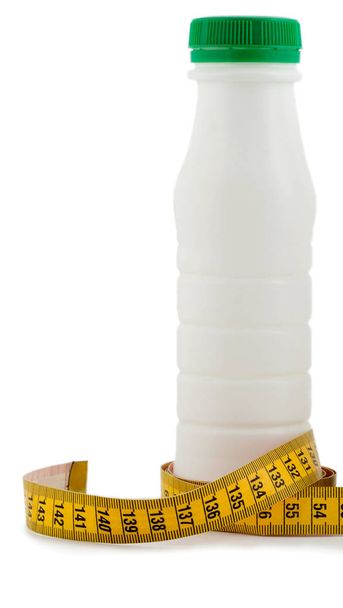 bottle milk with tape measure - Foto, imagen