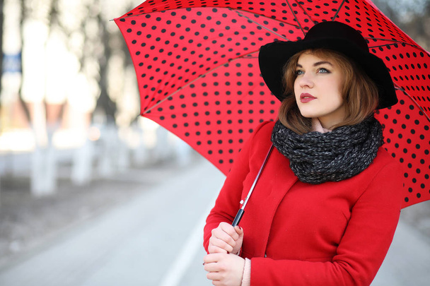 Pretty girl on a walk with an umbrella in the city - Photo, Image
