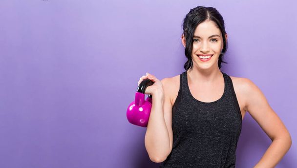 Happy woman working out with kettlebell - Zdjęcie, obraz