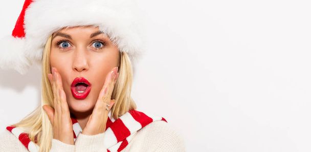 Happy young woman with Santa hat - 写真・画像