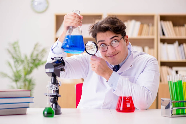 Mad crazy scientist doctor doing experiments in a laboratory - Photo, Image