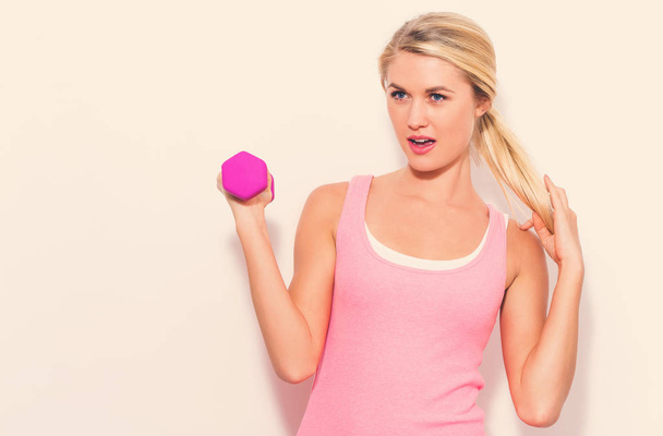 Young woman working out with dumbbell - Photo, Image