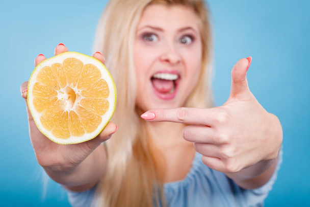 Woman pointing on grapefruit citrus fruit - Photo, image
