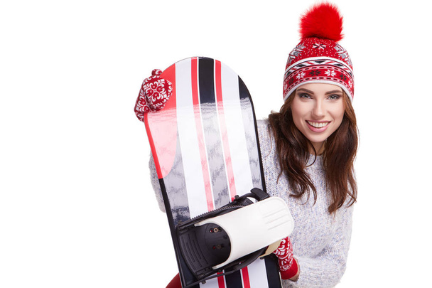 Woman holding a snowboard in studio - Fotoğraf, Görsel
