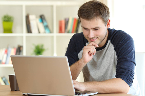 Man finding interesting content on line in a laptop - Fotó, kép