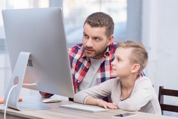 father and son with desktop computer - Photo, image
