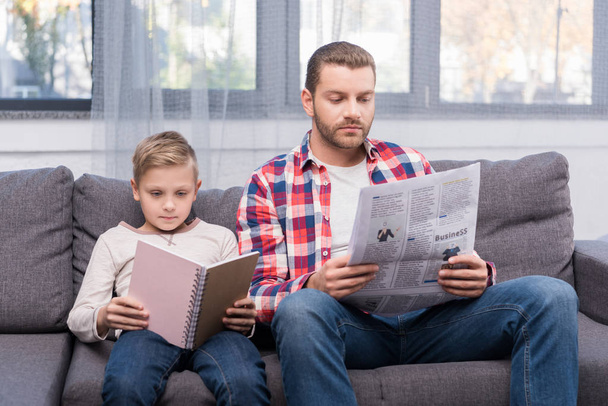 pai e filho lendo em casa
 - Foto, Imagem