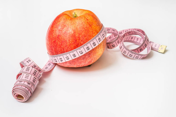 Red apple with measuring tape - diet concept - Photo, Image