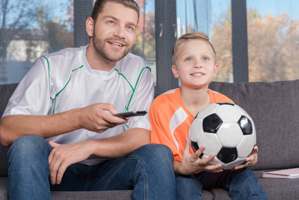 father and son watching soccer match - Valokuva, kuva