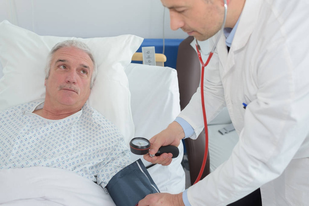 doctor examining a senior patient - Foto, imagen