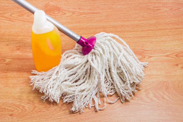 Classic mop and floor cleaner on a wooden floor  - Photo, Image