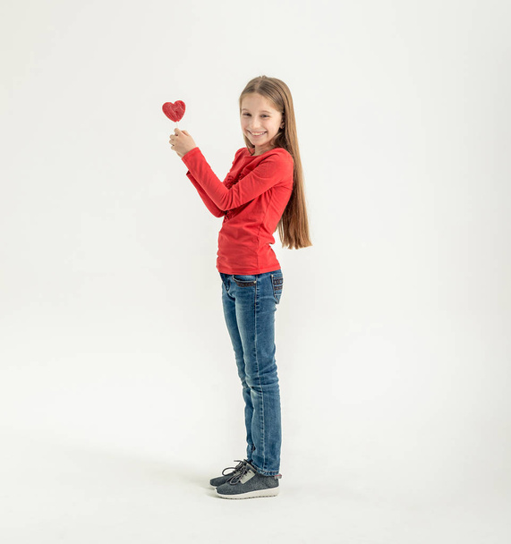 teenage girl with heart shaped lollipops - Фото, изображение