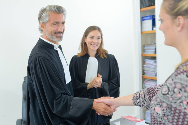 happy lawyers shaking hands with client - Fotó, kép