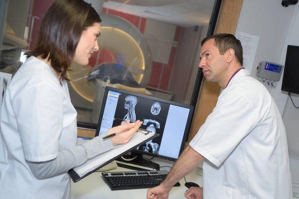 two doctor examining x-ray film of patient - Foto, afbeelding