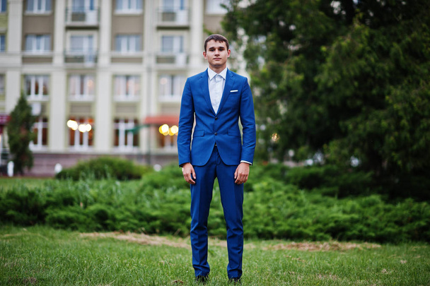 Portrait of a handsome young guy dressed in cool suit posing on  - Fotó, kép