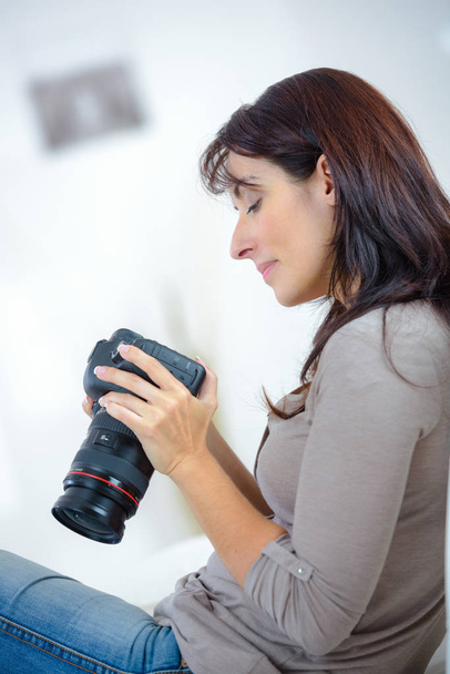 woman review photographs on the camera screen - Photo, Image