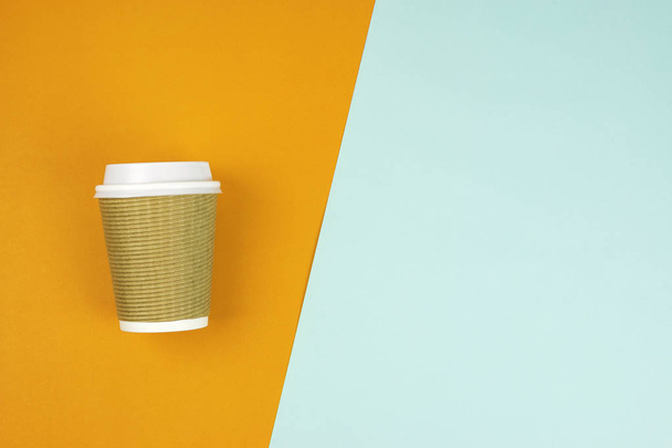Flat lay of Take out paper coffee cup on blue and orange background - Photo, Image