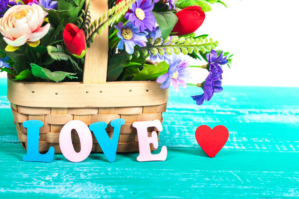 color love letters on wood with flower basket - Foto, imagen
