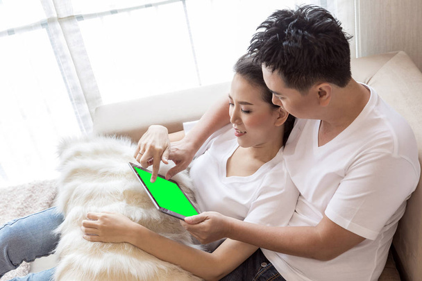Asian Couple using digital tablet  - Фото, изображение