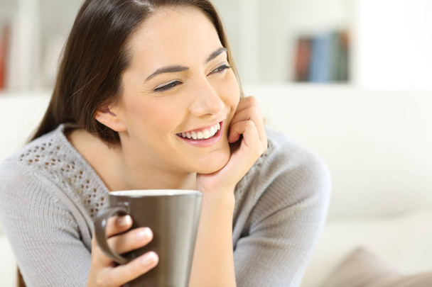 Happy woman holding a cup of coffee - Photo, Image