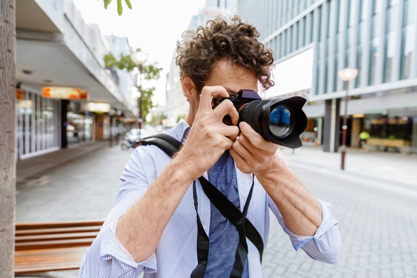 Male photographer taking picture - 写真・画像