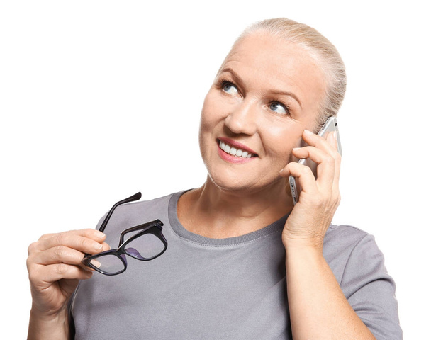 Senior woman speaking on cell phone, isolated on white - Fotoğraf, Görsel