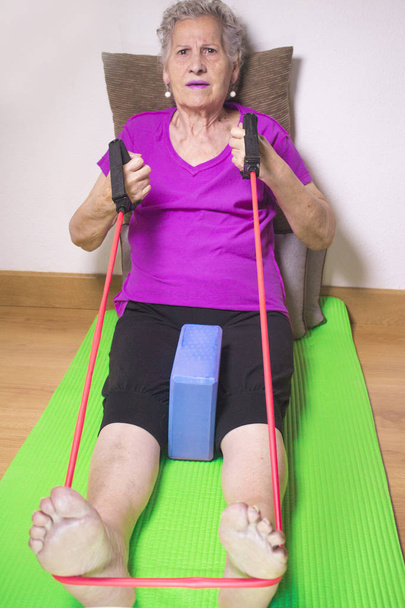 Rehabilitation exercises for older women with elastic band - Photo, image