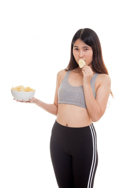Beautiful Asian healthy girl  eat potato chips. - Фото, изображение