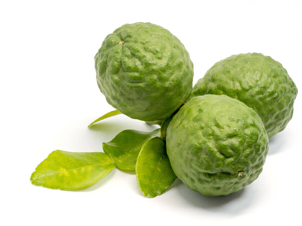 close up group of fresh bergamot with green leaves isolated on white background. benefits of bergamot for beauty and health concept - Foto, Imagen