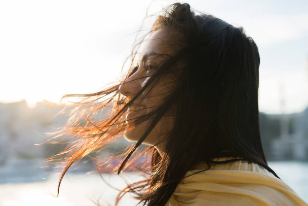 Portrait of a happy girl with tangled hair, strong wind - Fotoğraf, Görsel