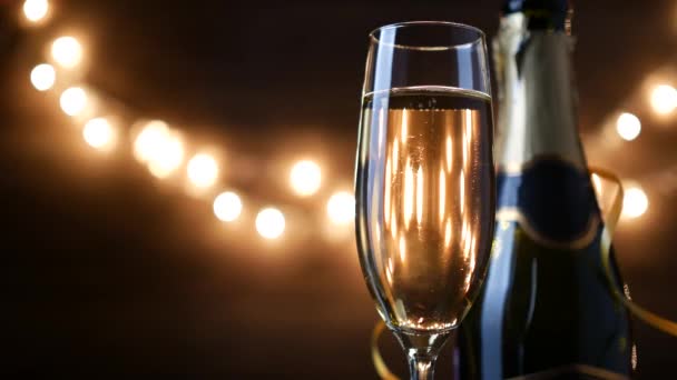 Toasting Champagne with holiday Bokeh Blinking Background. 4k footage - Materiał filmowy, wideo