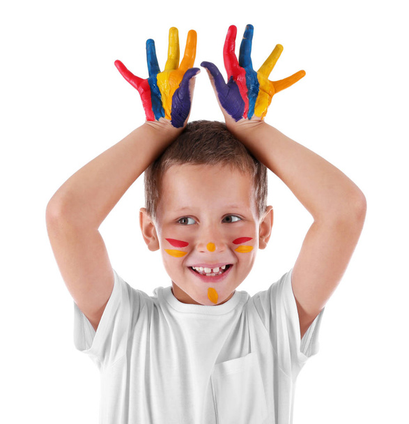 Cute boy with paint on face and hands against white background - 写真・画像