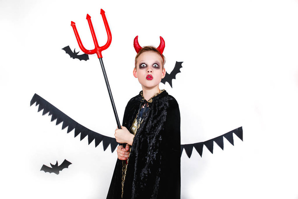 holiday halloween. funny child in carnival costumes devil on a white background - Foto, Imagen
