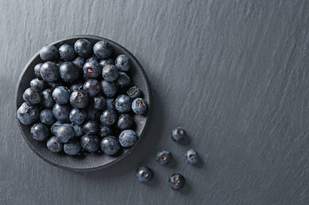 Plate with fresh acai berries on table - Zdjęcie, obraz