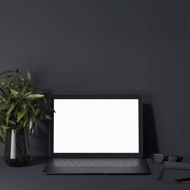 Black laptop in a dark room. 3d rendering - Фото, изображение