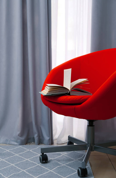 Chair with book near beautiful curtains indoors - Fotoğraf, Görsel