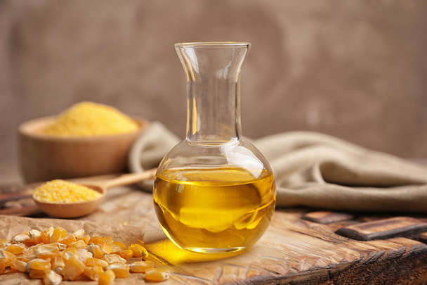 Decanter with corn oil and dried kernels - Photo, image