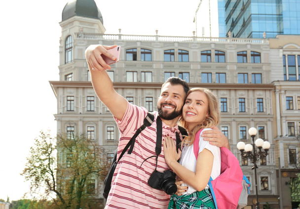 Happy young tourists taking selfie outdoors - Φωτογραφία, εικόνα