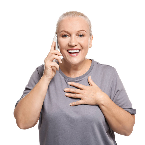 Senior woman speaking on cell phone, isolated on white - Foto, afbeelding