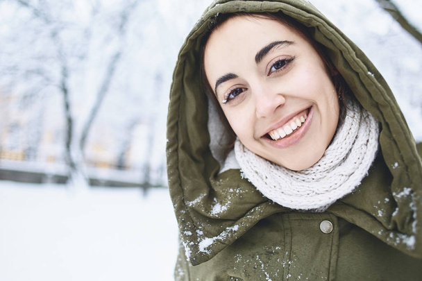 Close up Portrait of young woman outdoors at winter street. - Photo, Image