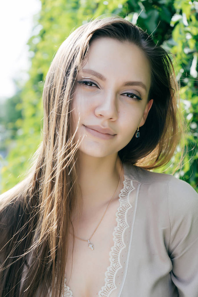 young beautiful girl in fashionable beige dress smiling and looking at camera - Foto, Bild