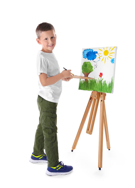Talented boy painting on canvas against white background - 写真・画像