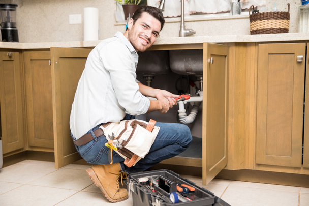 Handsome plumber doing some work - Photo, Image