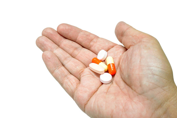 Cápsula e comprimido de medicamento à mão
 - Foto, Imagem