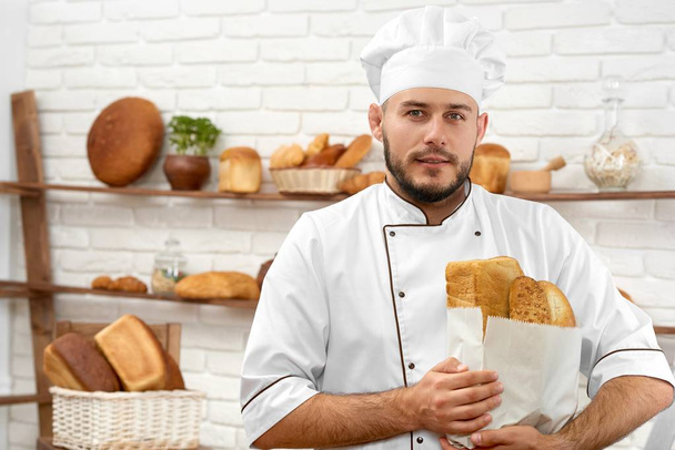 Young man working at his bakery - Фото, изображение
