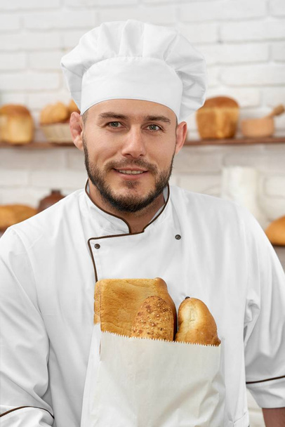 Young man working at his bakery - Fotó, kép