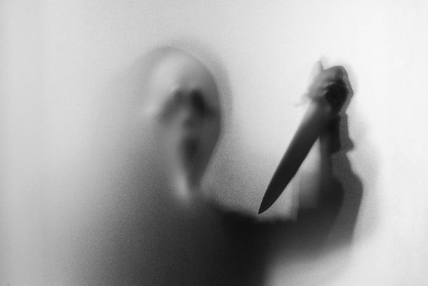 Shadow blur of horror man in screaming mask and show knife in hi - Photo, Image