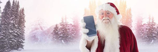 Joulupukki talvella puhelimen kanssa
 - Valokuva, kuva