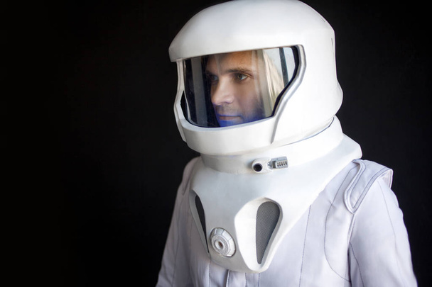 Astronaut in a helmet looks down. Fantastic space suit. Exploration of outer space. - Fotografie, Obrázek